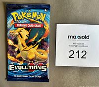 Front of sealed Pokémon XY Evolutions booster pack showing Charizard artwork and 10 card count