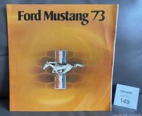 Front cover with Ford Mustang ’73 title and emblem