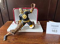 Front view of Gerry Cheevers action figure kneeling in crease on base with goal net