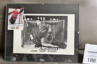 Framed signed photo with trading card visible