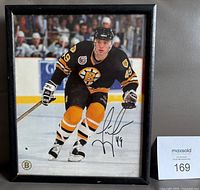 Full view of framed signed Joe Juneau photo