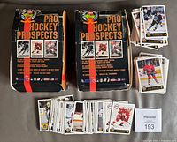 Two original Classic Pro Hockey Prospects boxes with stacks of loose cards and several cards displayed on top