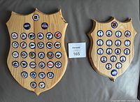 Both wooden plaques front view showing bottle caps and relative sizes