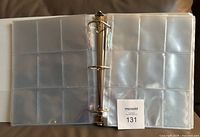 Binder opened displaying clear 9-pocket pages inside