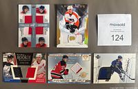 Front view of all five game-worn jersey cards