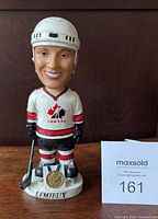 Front view showing full figure, uniform, base text and medal detail