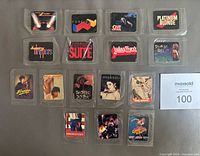 front view of 16 sealed stickers showing each artist