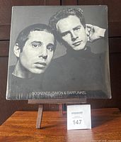 Front cover of sealed Bookends LP on easel