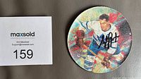 Front of round rubber coaster showing colour image of Syl Apps in Leafs uniform with autograph