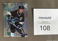 Front of 1996 Fleer Metal International Steel card signed by Wayne Gretzky in blue Sharpie