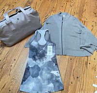 Full view of tank, cape, and duffle bag on floor