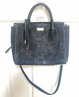 Front view showing croc-embossed exterior, top handles, detachable strap