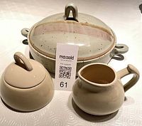 Casserole with lid, creamer, covered sugar displayed together