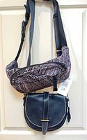 Both bags hanging: Lululemon printed belt bag above Roots navy leather crossbody