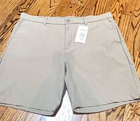 Front view of light khaki Original Penguin shorts showing flat front and attached tag