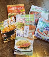 All six Taste of Home cookbooks displayed