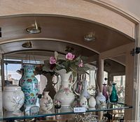 Full view of shelf showing all porcelain, ceramic and glass pieces
