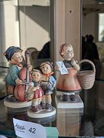 Three figurines displayed together