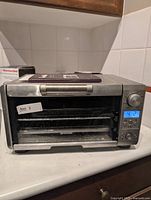 Front view of Breville Mini Smart Oven showing control panel and overall exterior condition