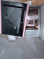 Back view of Smartparts digital frame inside open box with user manual