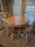 round table with four of six chairs around it