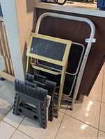 Group view of two ladders and two folding stools