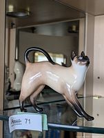 Full view of Royal Doulton Siamese cat figurine on shelf