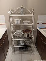 Front view of white metal five-tier baker’s rack showing overall design and shelves