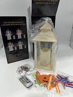 Boxed lantern sets with one lantern unwrapped, accessories and remote visible