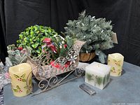 Overall lot showing candles, sleigh, greenery arrangements