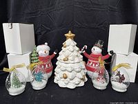 Full lot showing ceramic tree candle centered, two resin snowmen, four glass displays, and white storage boxes