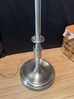 Weighted brushed stainless steel base, power cord visible