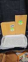 Two sealed boxes labeled Frisco Multi-Pet Feeding Station and one wrapped tray displayed