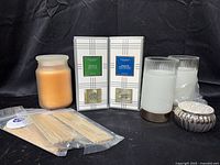 Group view showing both boxed diffusers, reed sticks, flameless candles, peach jar candle, trinket box