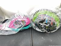 Two sealed kids helmets side by side