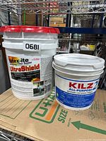 Front view of both buckets showing labels KILZ 2 primer and Latexite UltraShield sealer