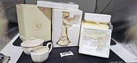 Group showing Lenox box, two styrofoam-packed figurines, Spode sugar bowl and creamer