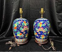 Front view of both ceramic floral lamps on wooden bases