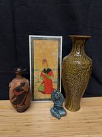 Group shot of all four items—painting, two vases, figurine