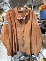 Front view of brown rawhide leather welding jacket on hanger