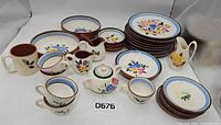 Full lot view showing stacks of plates, bowls, cups, pitchers
