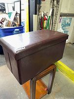 Closed brown vinyl storage ottoman bench