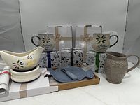 Group shot of all boxed mugs and plates, gravy boat with warmer, fish plate, embossed pitcher