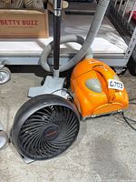 Hoover vacuum and Honeywell fan side by side