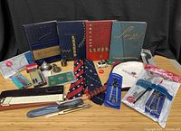 Overall lot overview showing yearbooks, drafting tools, collectibles