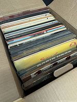 Top view of packed box showing several dozen record albums in sleeves