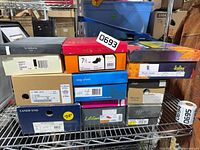 Stack of ten shoe boxes showing brands Nine West, Easy Street, Lands’ End, La Gear, Italian Shoemakers and others