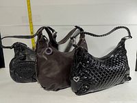 Front view of all three Brighton handbags