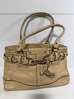 Front view showing overall style, handles, hardware, tassel