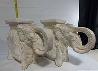 Pair of ceramic elephant stools side by side